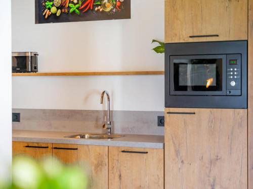 a kitchen with a sink and a microwave at Obermöschach 10B in Obermöschach