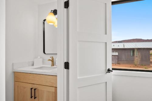 a bathroom with a sink and a mirror at Marble Canyon Lodge in Marble Canyon