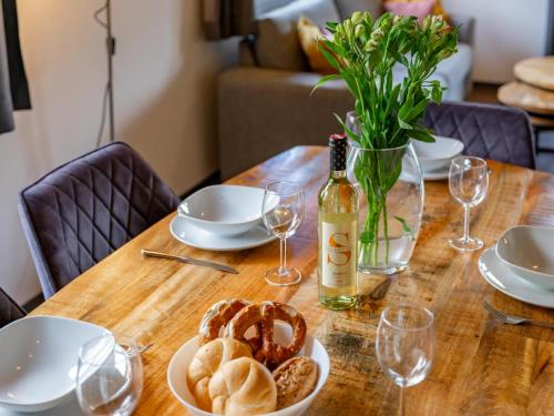 a table with a bottle of wine and a bowl of bread at Obermöschach 10B in Obermöschach