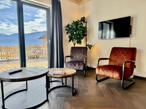 a living room with a table and chairs and a window at Obermöschach 10 in Obermöschach