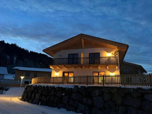 a house with lights on it in the snow at Obermöschach 10 in Obermöschach