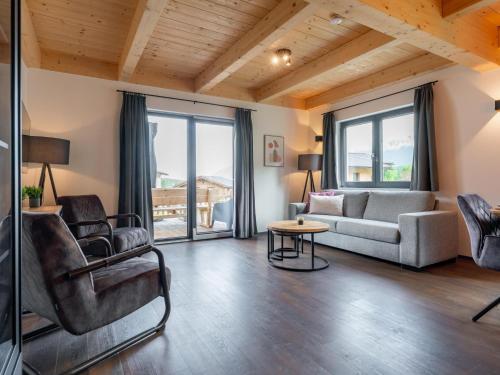 a living room with a couch and chairs and a table at Obermöschach 6A in Obermöschach