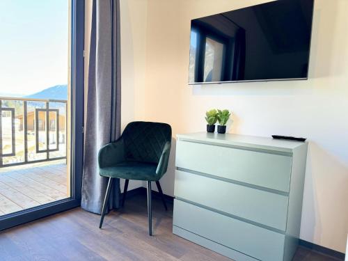 a chair sitting next to a dresser with a mirror at Obermöschach 6A in Obermöschach