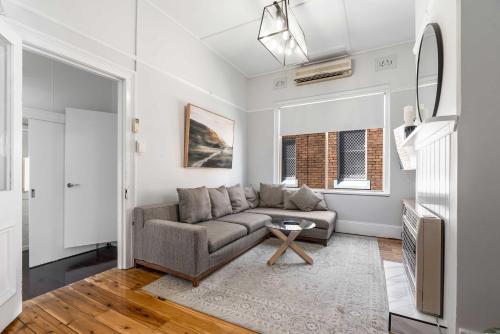 a living room with a couch and a tv at Incredible Location 2 Bed CBD Dream in Orange