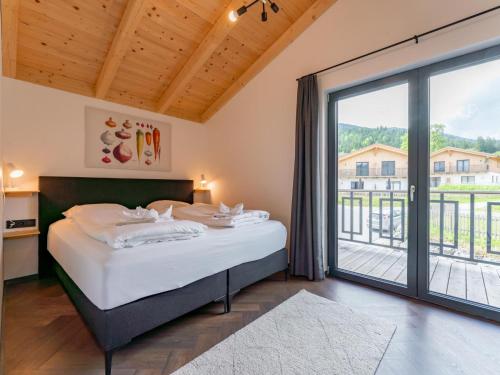 a bedroom with a bed and a large window at Obermöschach 10 in Obermöschach