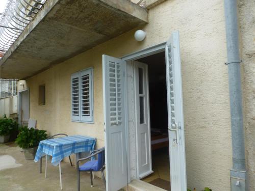 an open door to a patio with a table and chairs at Guesthouse Bracanović in Hvar