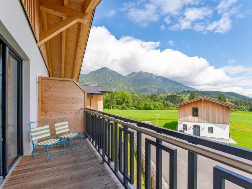 a balcony with two chairs and a view of mountains at Obermöschach 10 in Obermöschach