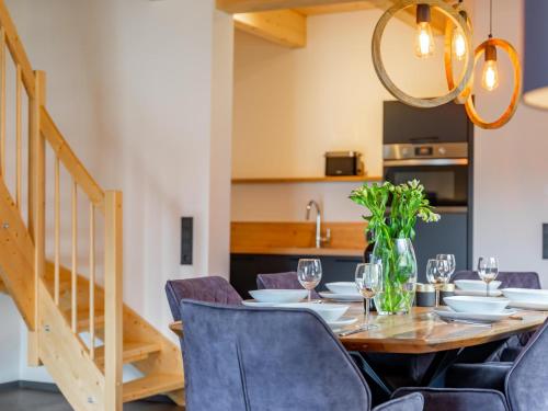 a dining room with a wooden table and chairs at Obermöschach 6B in Obermöschach