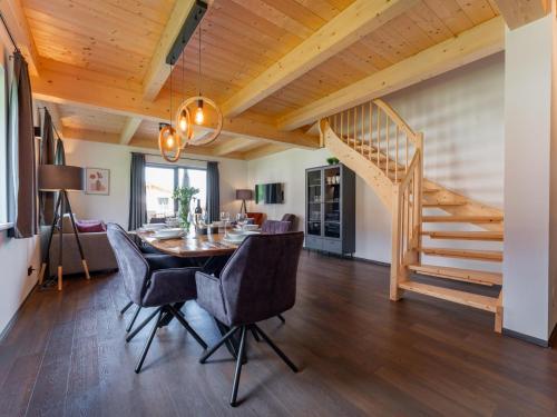a dining room with a table and chairs and a staircase at Obermöschach 6B in Obermöschach