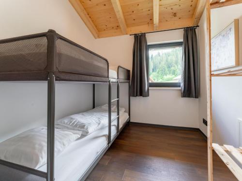 two bunk beds in a room with a window at Obermöschach 6 in Obermöschach