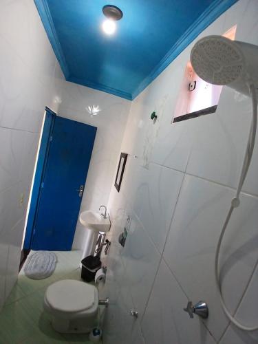 a bathroom with a shower with a toilet and a sink at Vip Girassol in Cuiabá