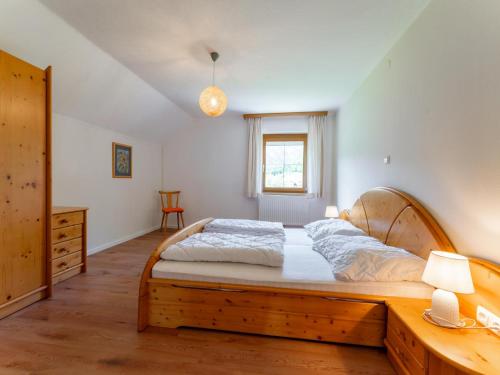 a bedroom with a large bed with a wooden frame at Jukbichl 2 in Laas