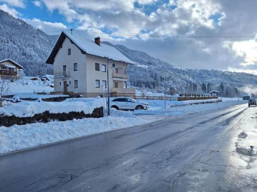 a house on the side of a road covered in snow at Jukbichl in Laas