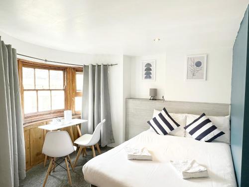 a bedroom with a bed and a table and chairs at Number 75 in Brighton & Hove