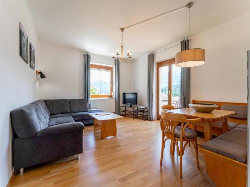 a living room with a couch and a table at Jukbichl in Laas