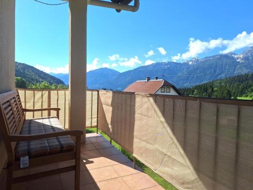 a balcony with a chair and a view of mountains at Jukbichl in Laas