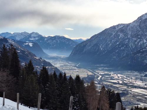 a view of a valley in the mountains with snow at Jukbichl in Laas