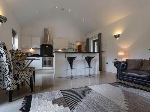 a living room with a couch and a kitchen at 1 Bed in Coniston LCC50 in Coniston