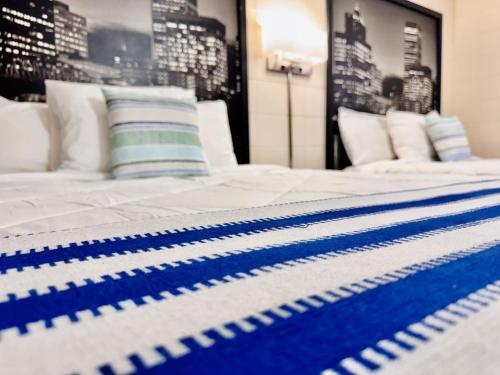 a bed with a blue and white blanket on it at Relax Inn At Ashland in Ashland