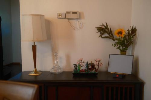 a table with a lamp and flowers on it at Modern Character Downtown Fargo in Fargo