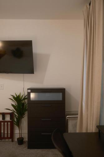 a living room with a tv and a curtain at Modern Character Downtown Fargo in Fargo