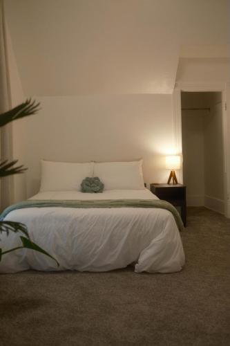 a bedroom with a white bed with a night stand at Modern Character Downtown Fargo in Fargo