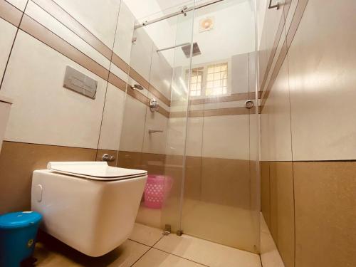 a bathroom with a toilet and a shower at Cozy Homestays in Ernakulam