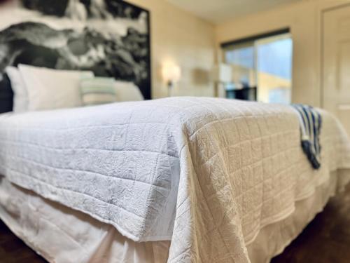 a bedroom with a bed with a white comforter at Relax Inn At Ashland in Ashland