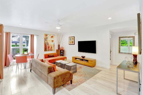 a living room with a couch and a tv at 320-1 Las Olas Boulevard in Fort Lauderdale