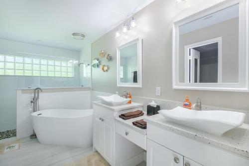 a white bathroom with two sinks and a tub at Luxury 3 Bed 2 Bath Home with Pool and Spa in Naples