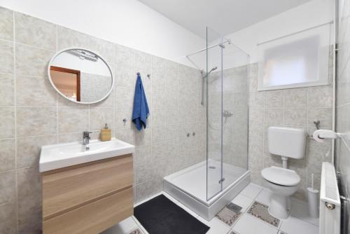 a bathroom with a shower toilet and a sink at Apartments with parking space Zagreb - 24661 in Zagreb