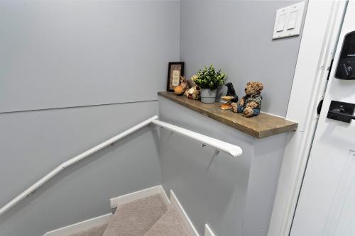 a stairway with a wooden shelf on the wall at Blissful Nest - Cozy, Classy 2 Bedroom Private Suite Netflix, free Parking, 20 minutes to West Edmonton Mall and Airport in Edmonton