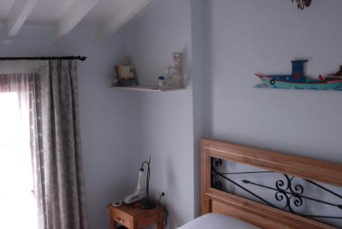 a bedroom with a bed and a window at Aliye Hanim Hotel in Ayvalık