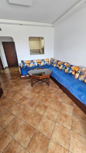 a blue couch in a living room with a table at La cassia in Cabo Negro