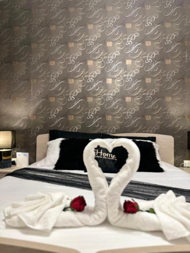 two swans made out of towels on a bed at Couple's Getaway in Is-Swieqi