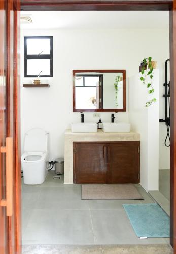 a bathroom with a sink and a mirror at Villa Pura Vida Apartments Siargao in General Luna