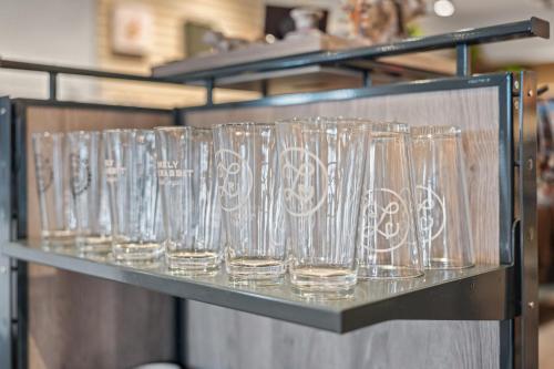 a row of wine glasses sitting on a shelf at Marble Canyon Lodge in Marble Canyon