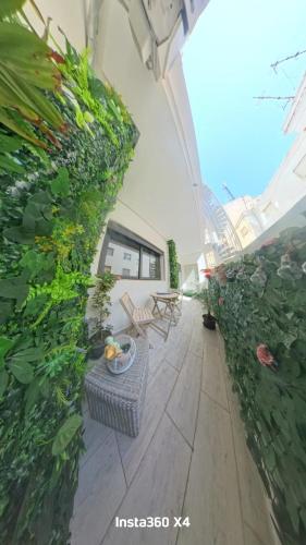 a patio with a table and chairs and plants at La costa KOala in Tangier