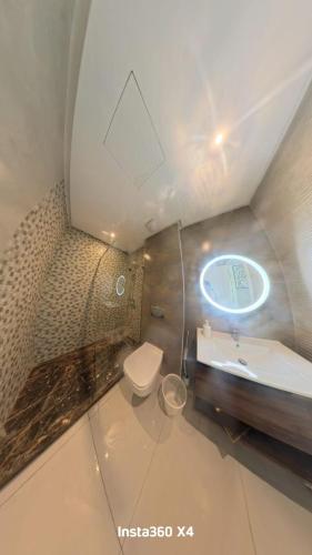a bathroom with a toilet and a sink and a mirror at La costa KOala in Tangier