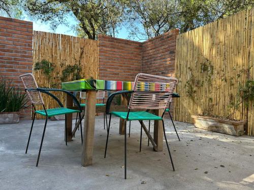 a table with two chairs and a table with a fence at Concept House in Banda