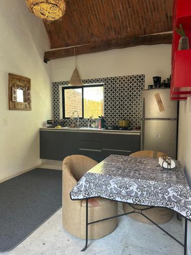 a kitchen with a table and a refrigerator at Concept House in Banda