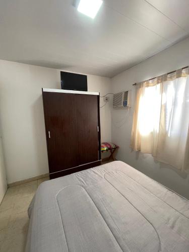a bedroom with a large bed and a window at Cabaña 32 termas in Chajarí