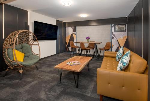 a living room with a couch and a table at Coast Metro Vancouver Hotel in Burnaby