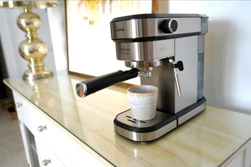 a coffee machine sitting on a counter with a cup at La Casa de las Musas, pequeño chalet junto al mar in Mojácar