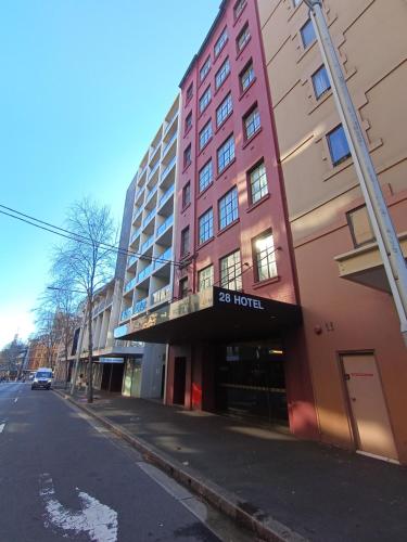 a pink building on the side of a street at 28 Hotel in Sydney