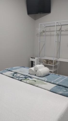 a bed with two pillows on it in a room at Aconchego de Espírito Santo do Pinhal in Espirito Santo Do Pinhal