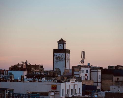 a clock tower on top of a city at hostel riad maqam in Essaouira