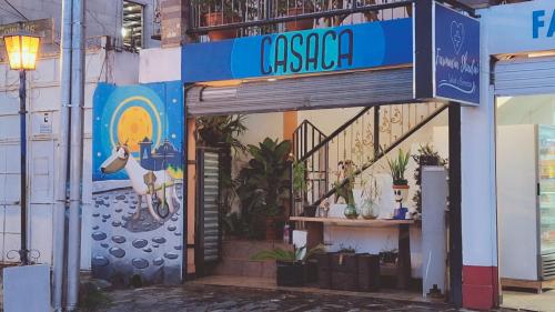a building with a sign that reads casa at Casaca in Concepción de Ataco
