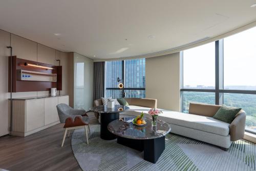 a living room with a couch and a table at Holiday Inn Changchun High Tech Zone by IHG in Changchun