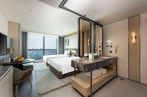 a hotel room with a bed and a large mirror at Holiday Inn Changchun High Tech Zone by IHG in Changchun